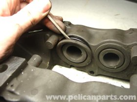 take away the external seal by prying it out for the caliper housing.
